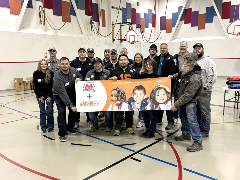 A group of people pose together indoors.