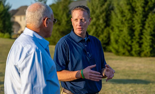 Rich St. Amour talking to a landowner