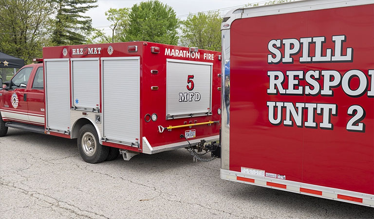 A red Marathon spill response vehicle with a trailer attached