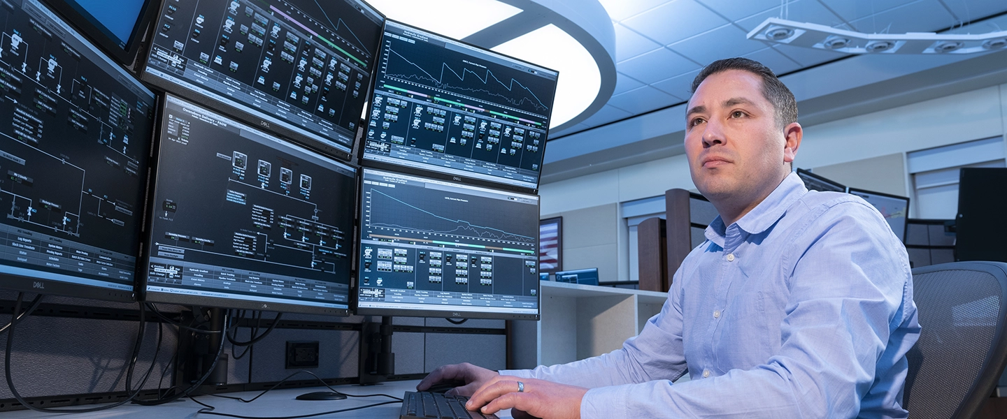 A Marathon Pipe Line operator working at a large data console at an Operation Center