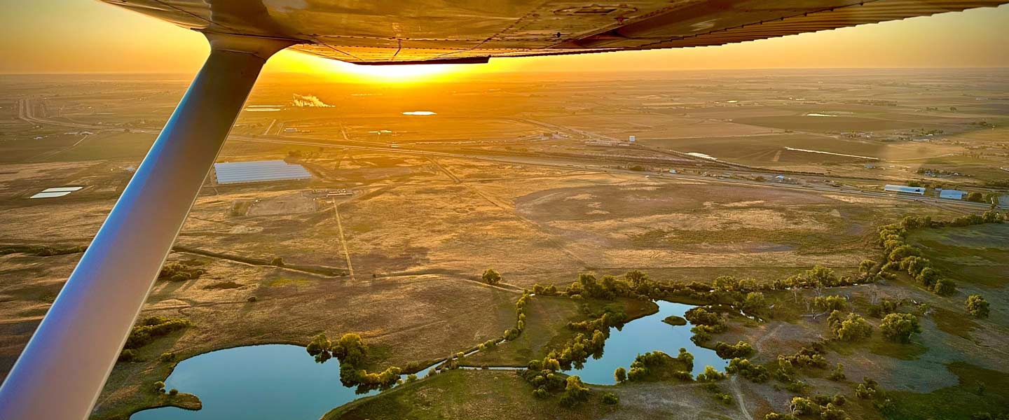 An aerial view of pipeline right of way land from an airplane wing