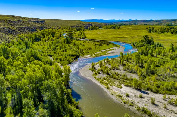 Aerial photo of a river bending into the distant horizon
