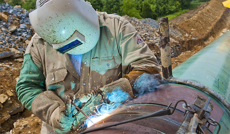 A Marathon Pipe Line technician welding a cracked pipeline pipe
